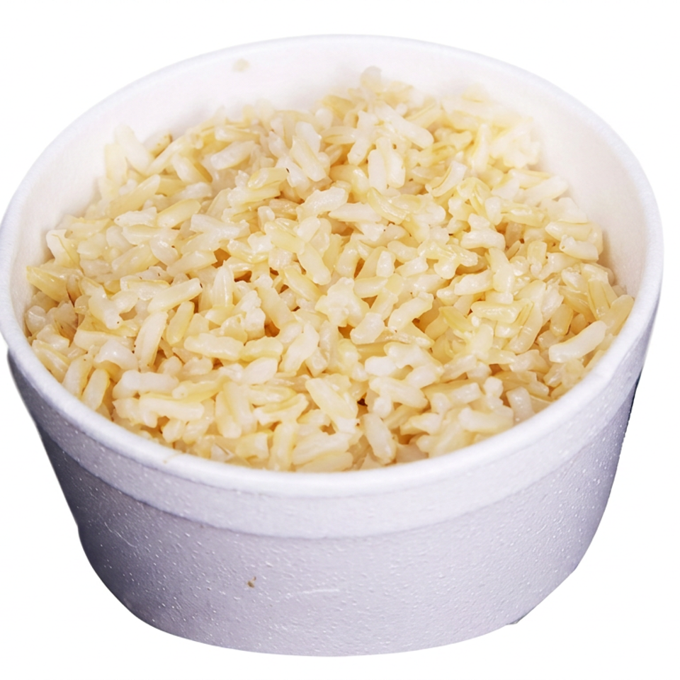 A white bowl filled with seasoned yellow rice on a plain white background.